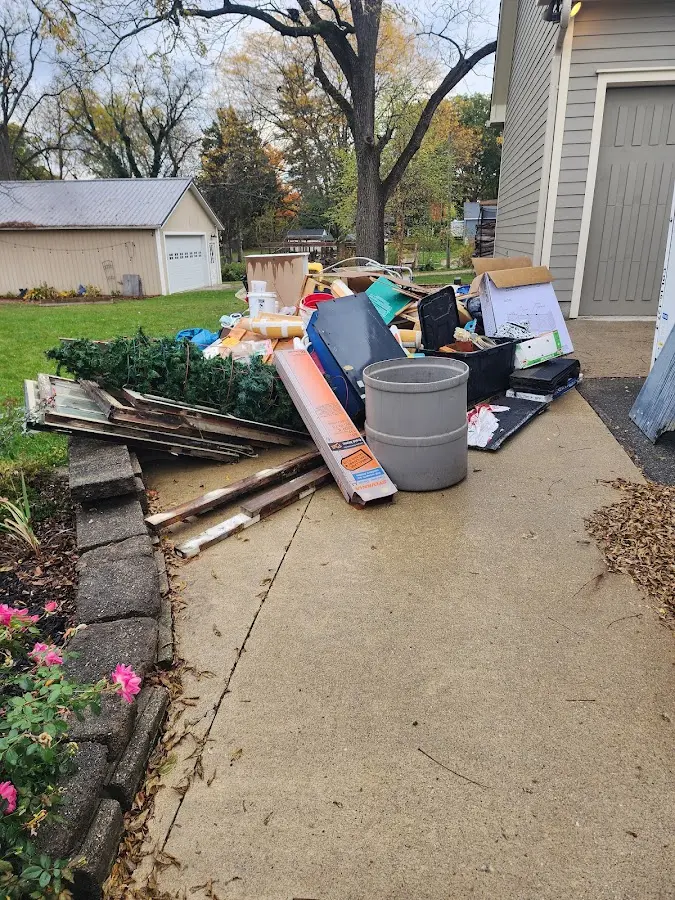 Dumpster being loaded with debris for 10 Yard Dumpster Rental in Dranesville